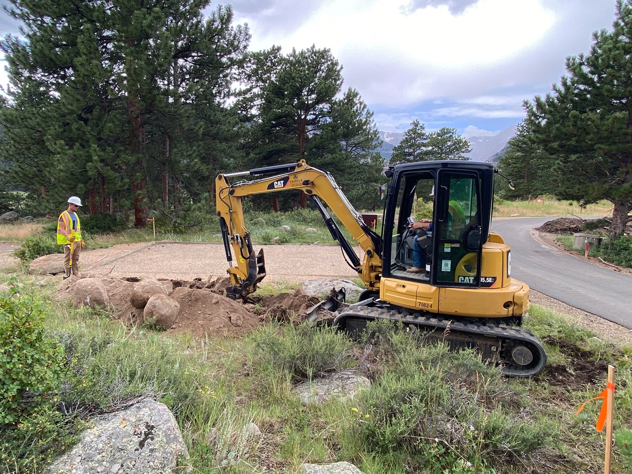 Digging a trench for new electric wiring at a campsite