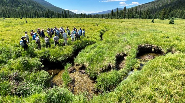 A group of KVERC collaborators near a dry stream channel during a site visit to the valley.