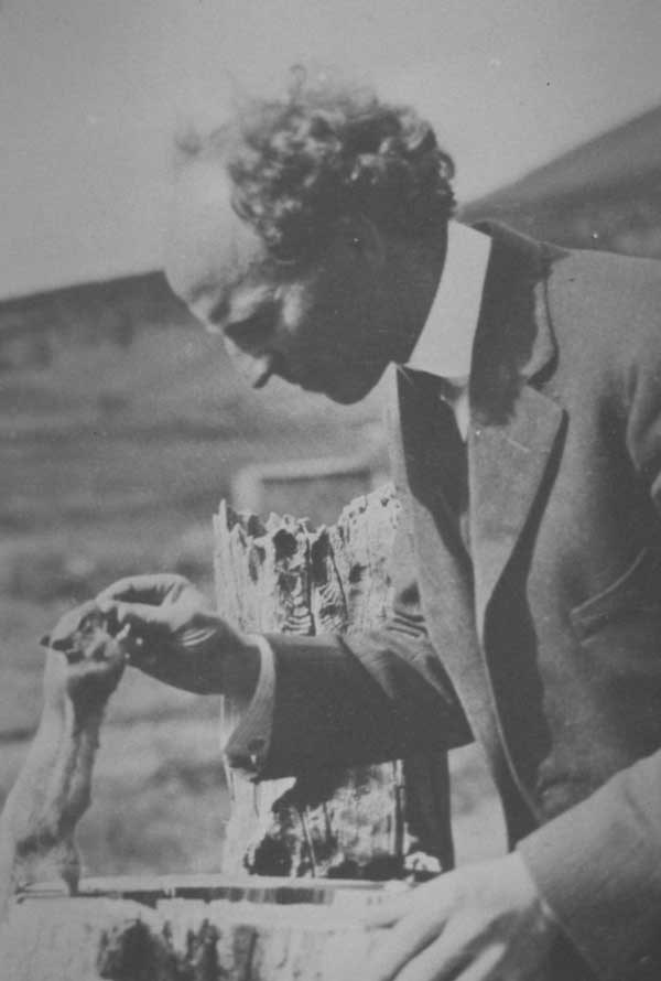 an historic photo of Enos Mills feeding chipmunk