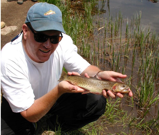 a photo of researcher holding trout
