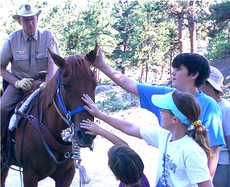 a photo of a park volunteer on horse patrol