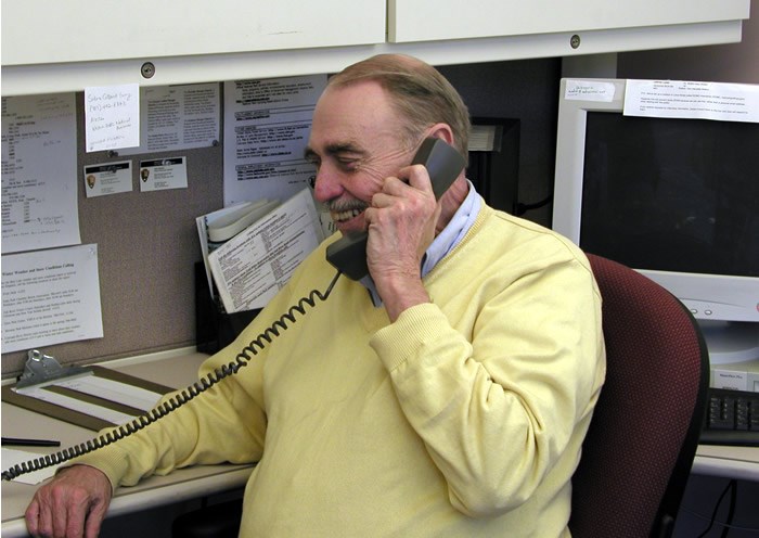 a photo of an Information Office volunteer answering the phone