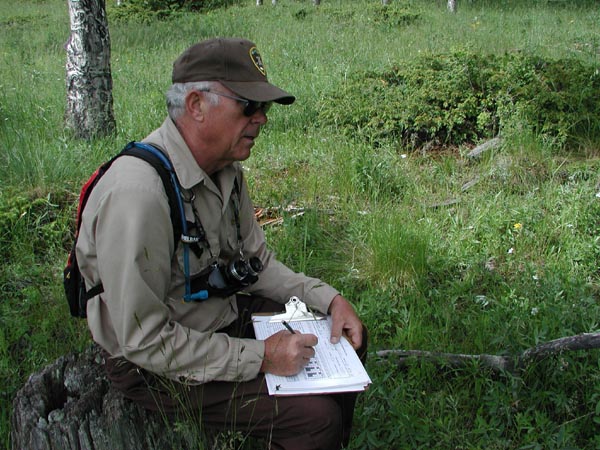 a photo of researcher doing cavity nesting survey