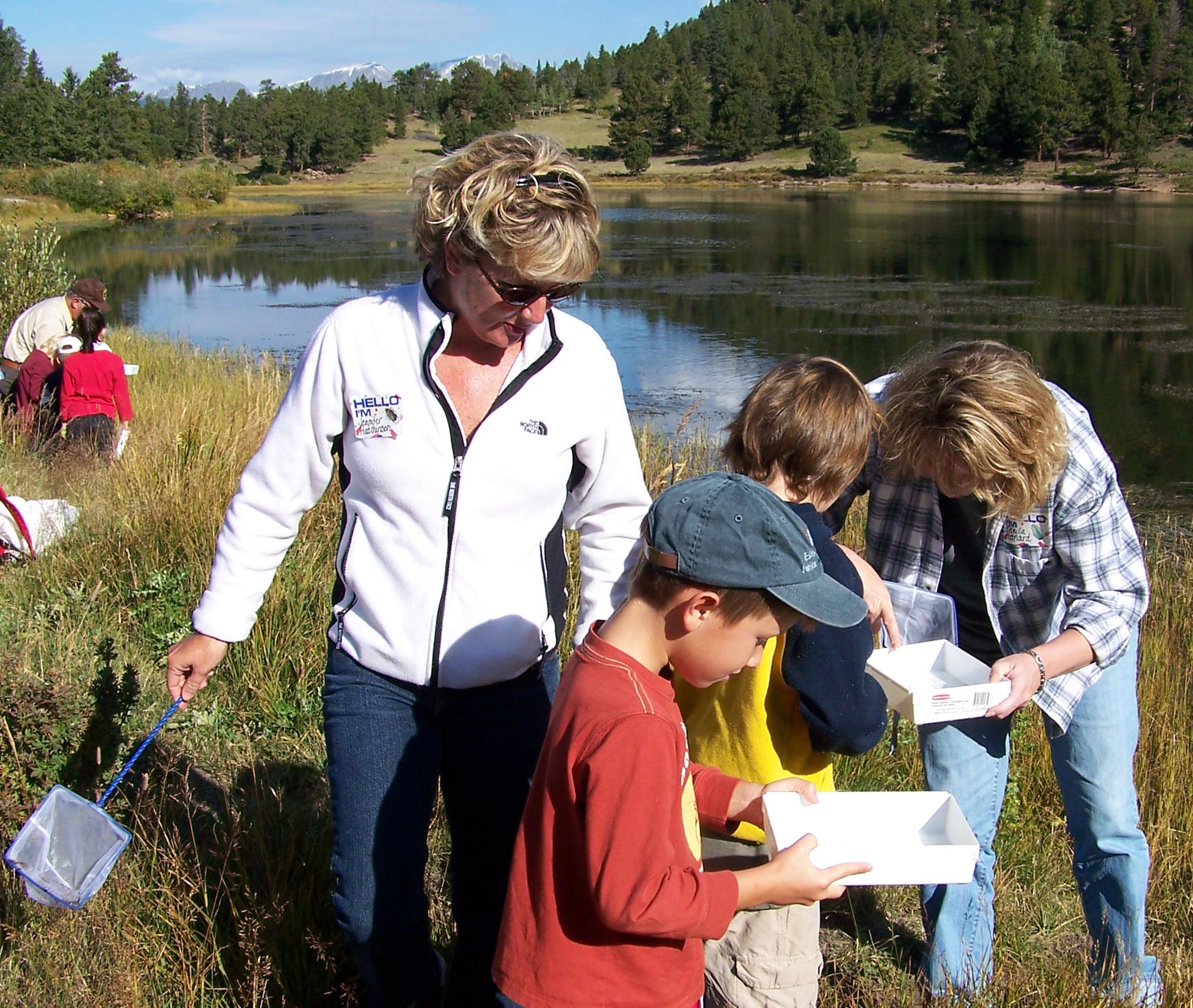 Teachers assist students exploring nature. Teachers assist students exploring nature.