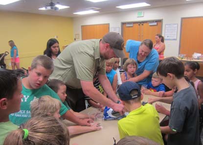 Teacher-In-Residence Ranger Trevor leads a summer library program activity. Teacher-In-Residence Ranger Trevor leads a summer library program activity.