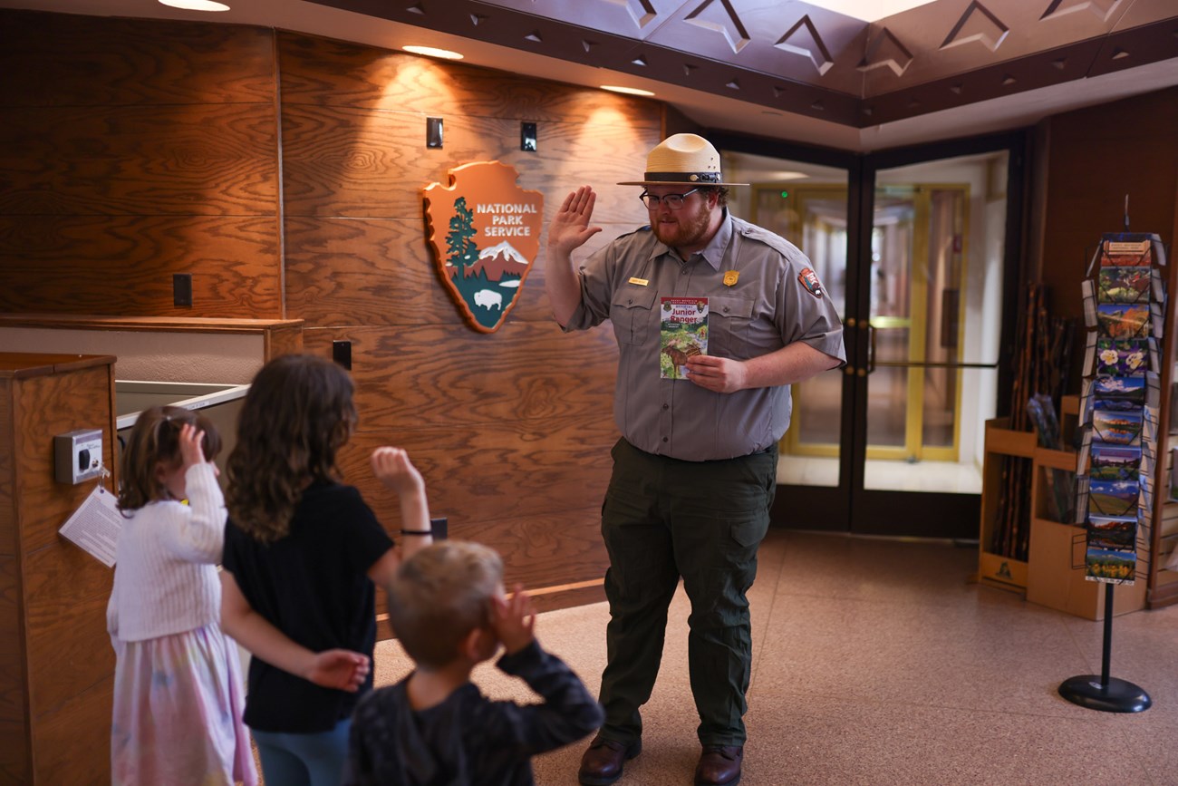 Three Junior Rangers are being sworn in to earn their new badges