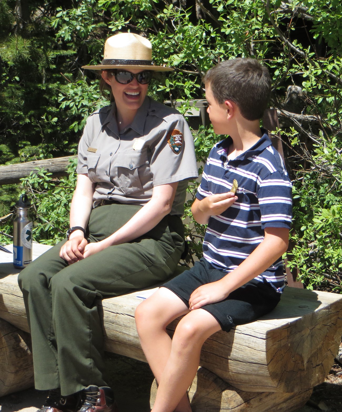 RMNP Ranger congratulates a new Junior Ranger child