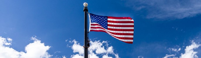 American flag with blue sky