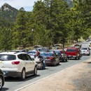 A line of cars at a park entrance station