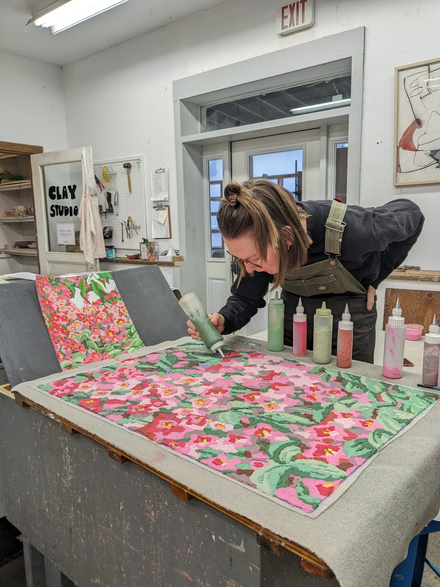 Artist Claudia Borfiga adding color to screen print.