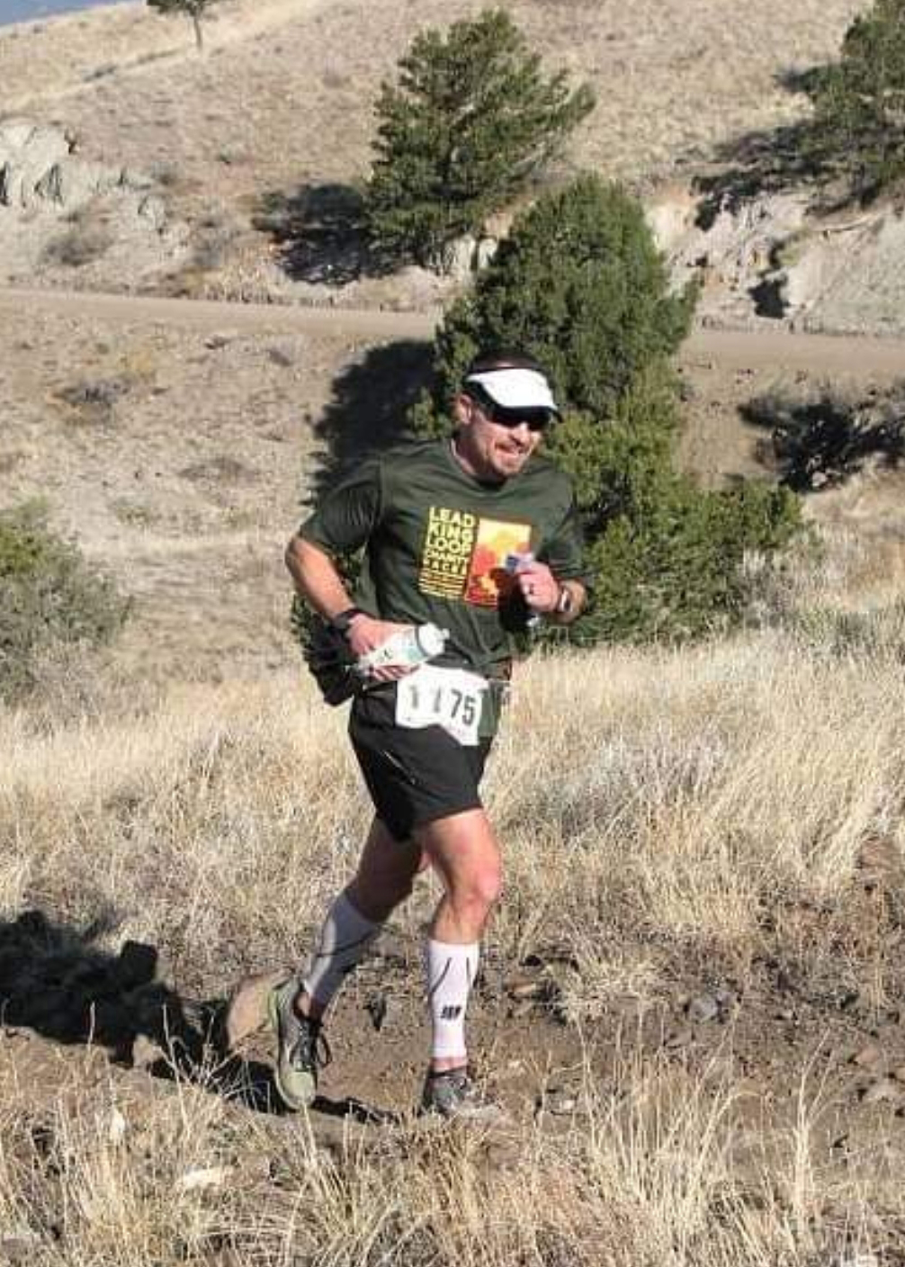 Image of Chad Pallansch running on a trail, wearing shorts and a t-shirt