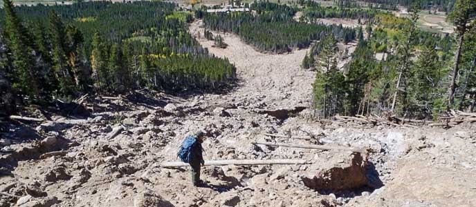 A park ranger stands on the Twin Sisters debris flow