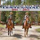 Park Rangers on Horseback underneath a Centennial Banner