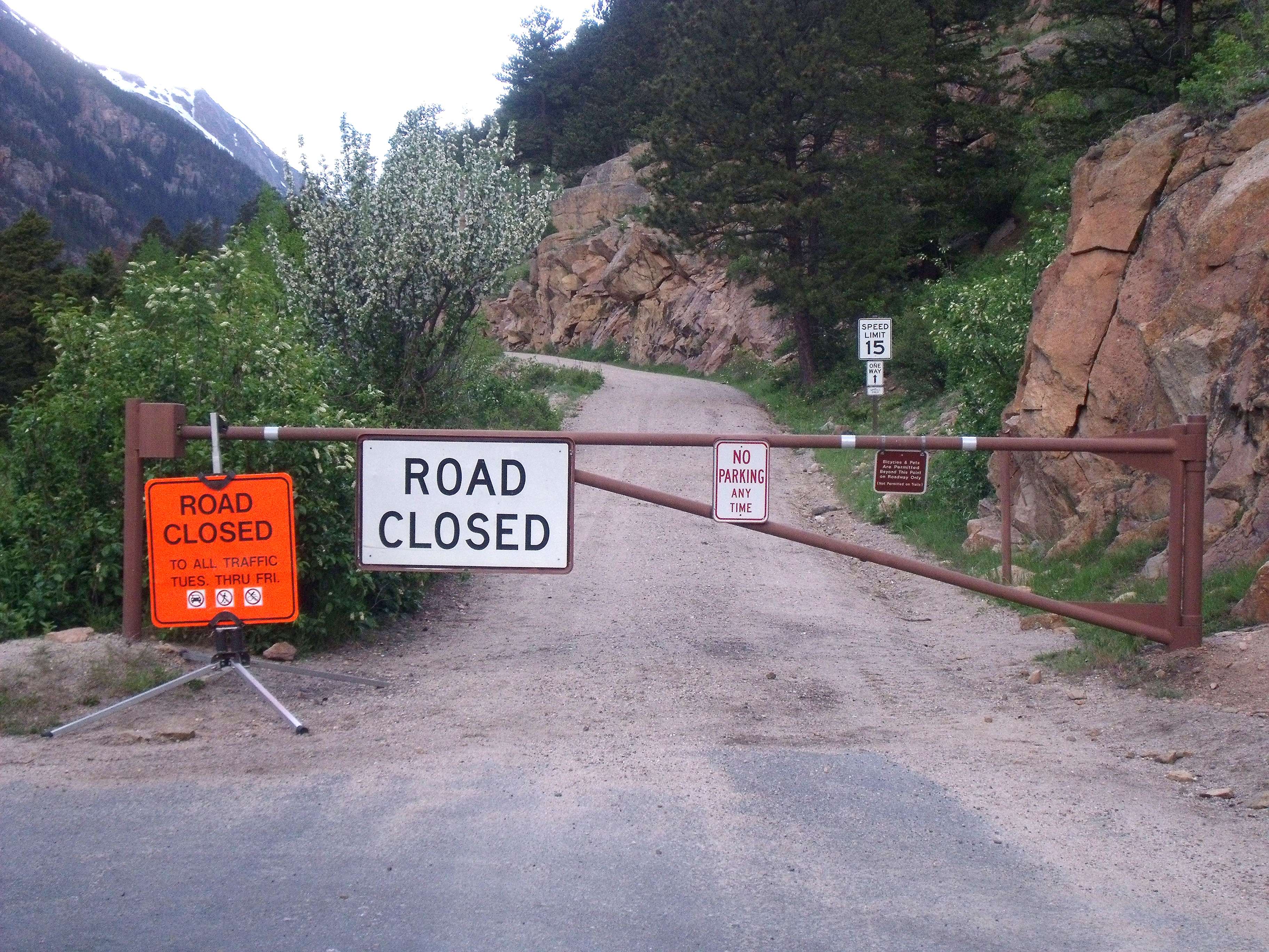 Old Fall River Road Spring Closure for Maintenance Sign and Gate compressed Signs near closed gate on Old Fall River Road