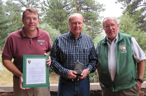 Photo Ben Bobowski, Chief of Resource Stewardship and Vaughn Baker Superintendent present award to Bruce Rosenlund.