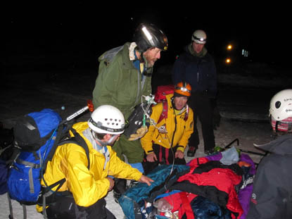 Photo Rescue team with injured skiier at the Bear Lake Trailhead following his evacuation from the backcountry in Rocky Mountain National Park.