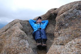 Photo Renelle demonstrates rock along Gem Lake Trail makes a perfect chair.