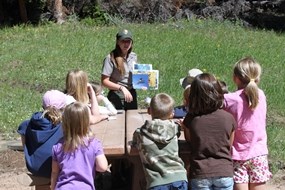 Ranger Chelsea gives a program to a group of children.
