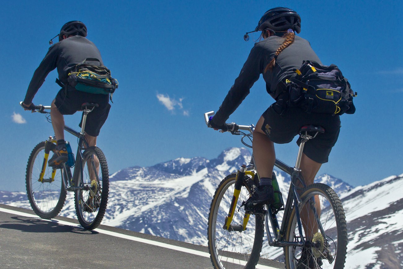 Two people are biking on Trail Ridge Road