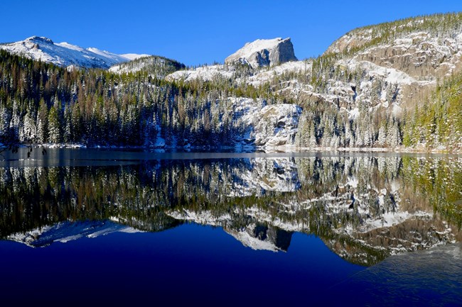 Bear Lake in winter with a reflection of Hallett Peak