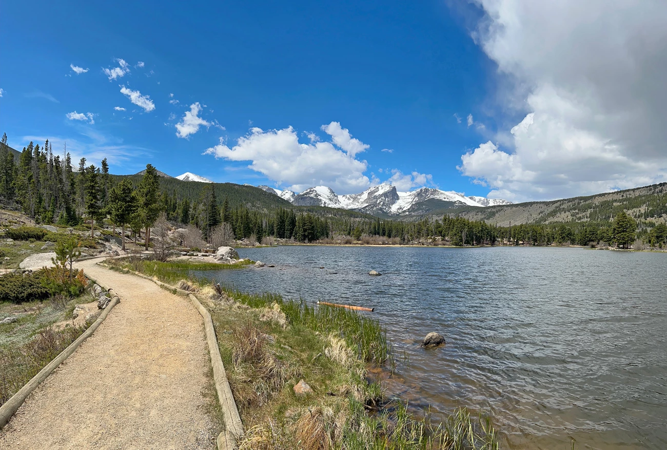 Sprague Lake Trail, taken May 23, 2025 Sprague Lake Trail with snowy mountain peaks along the Contintental Divide is the distance