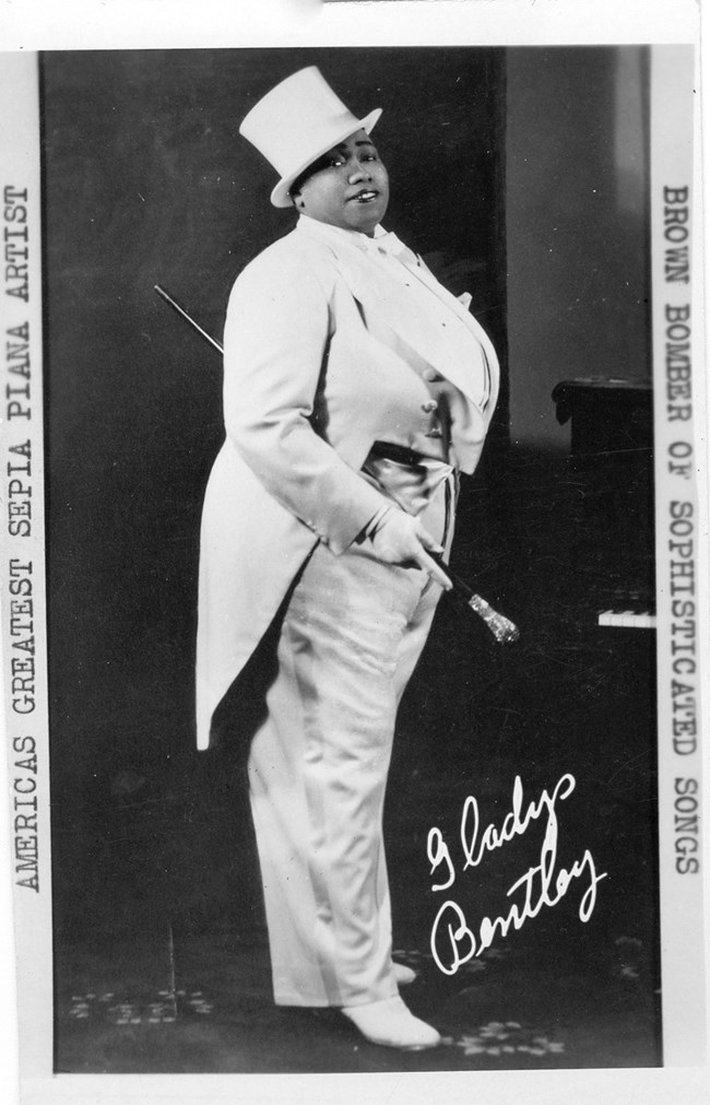 African American woman in a suit and top hat. Historic photo.