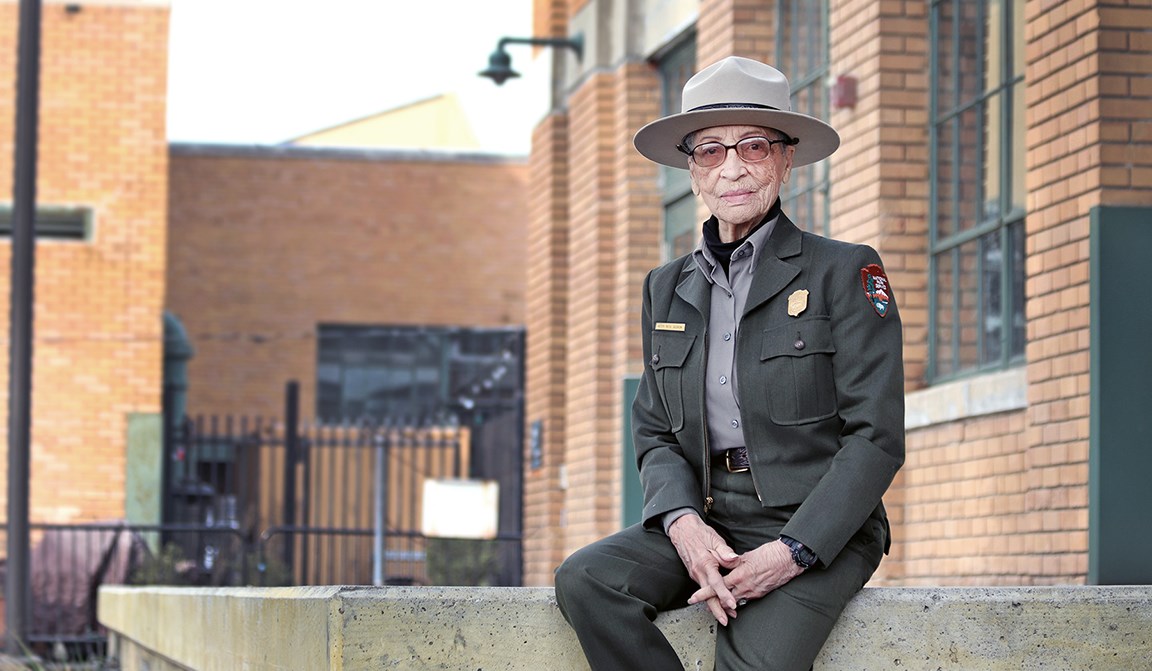 Ranger Betty Soskin sitting in front of the visitor center.