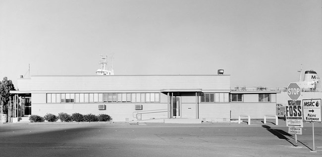 Historic black and white photo of single story building from 1940's.