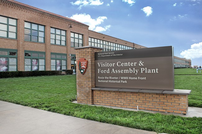 Large brick entrance sign and large brick building.