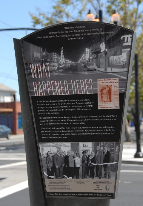 Metal sign depicting historic photos and text about Richmond.