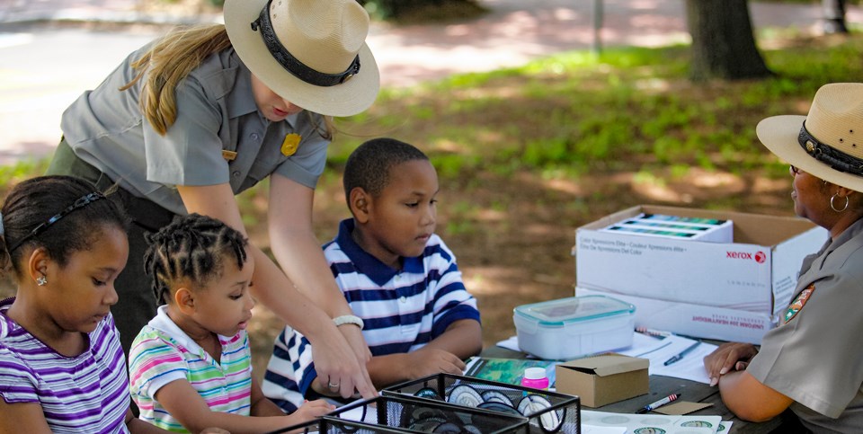 Three young kids becoming junior rangers