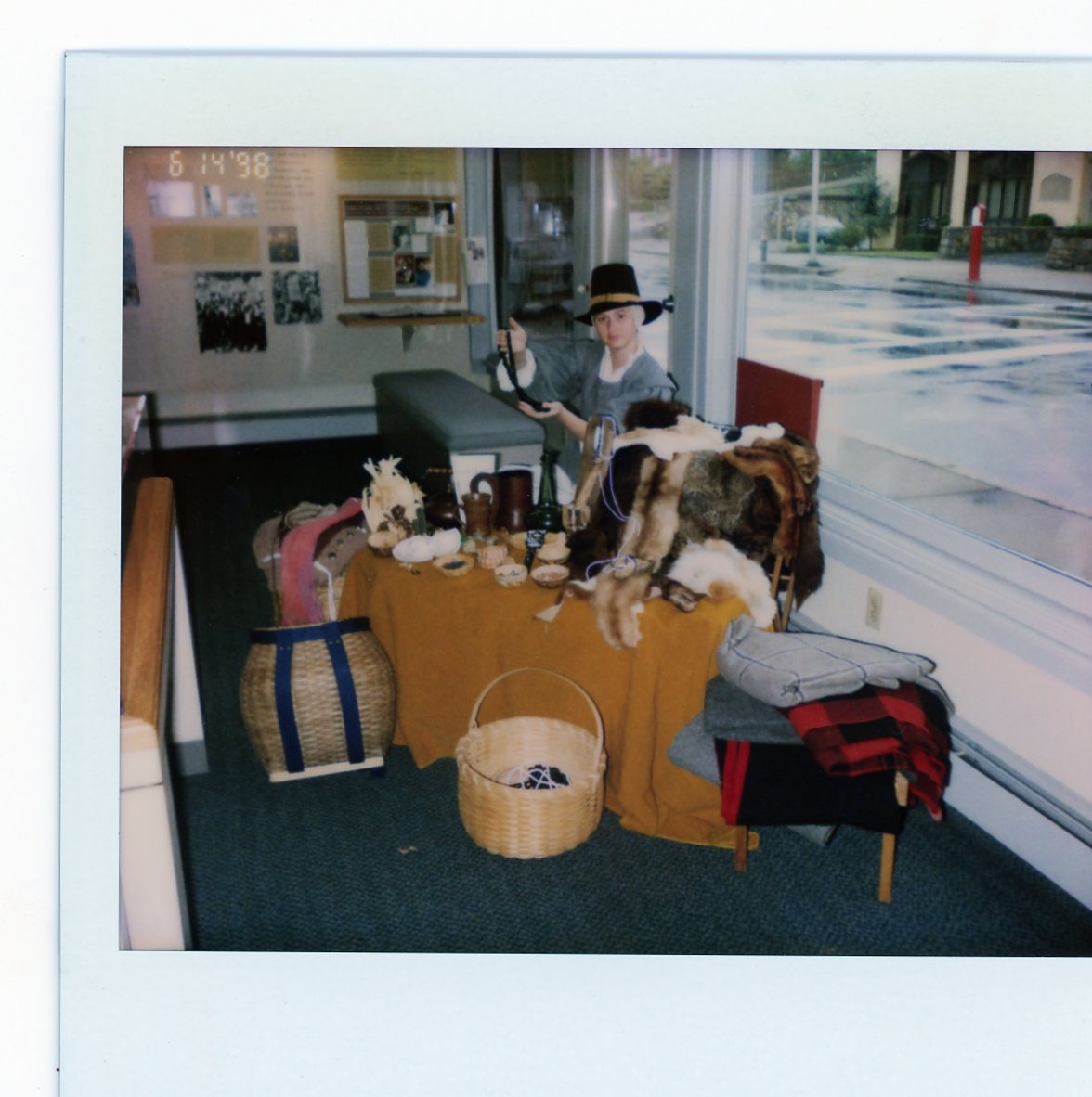 A costumed interpreter teaching about a variety of indigenous goods