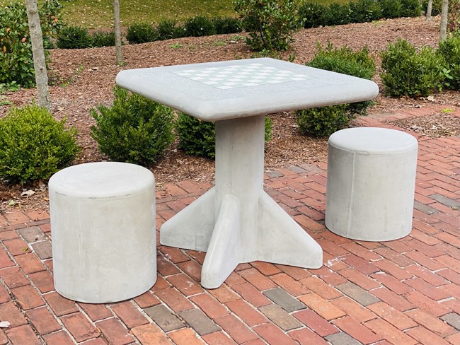 A concrete chess table with stools