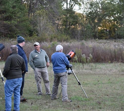 Several volunteers prepare to present to the public outside
