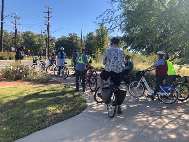Park Ranger leads bike program group on trail at Mission San Juan