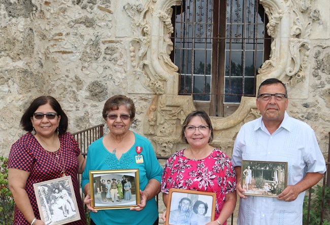 Family standing in front of the Rose window