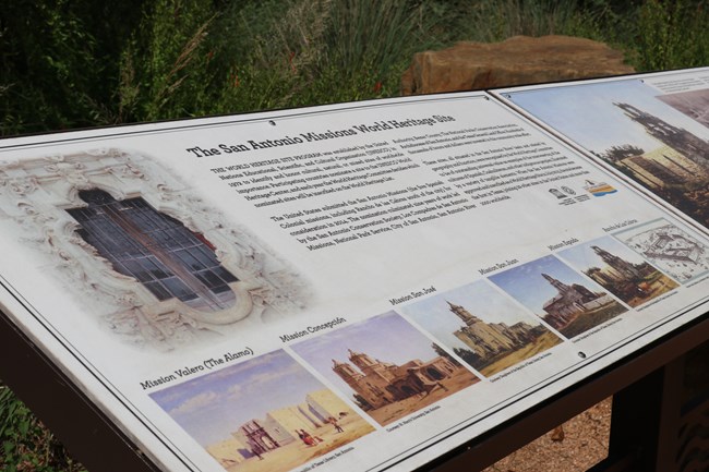 Tan wayside with black text reads "The San Antonio Missions World Heritage Site" with a photo of the limestone carved rose window.