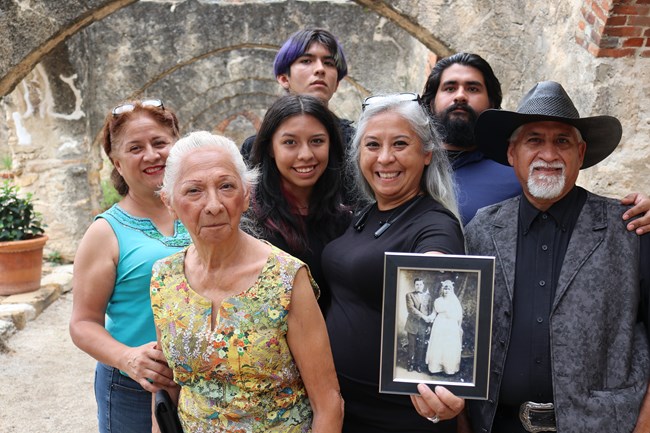 Family posing for a picture in the convento of Mission San Jose.