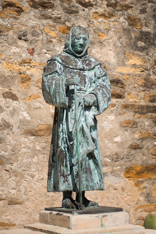 Mission era black statue of saint at park