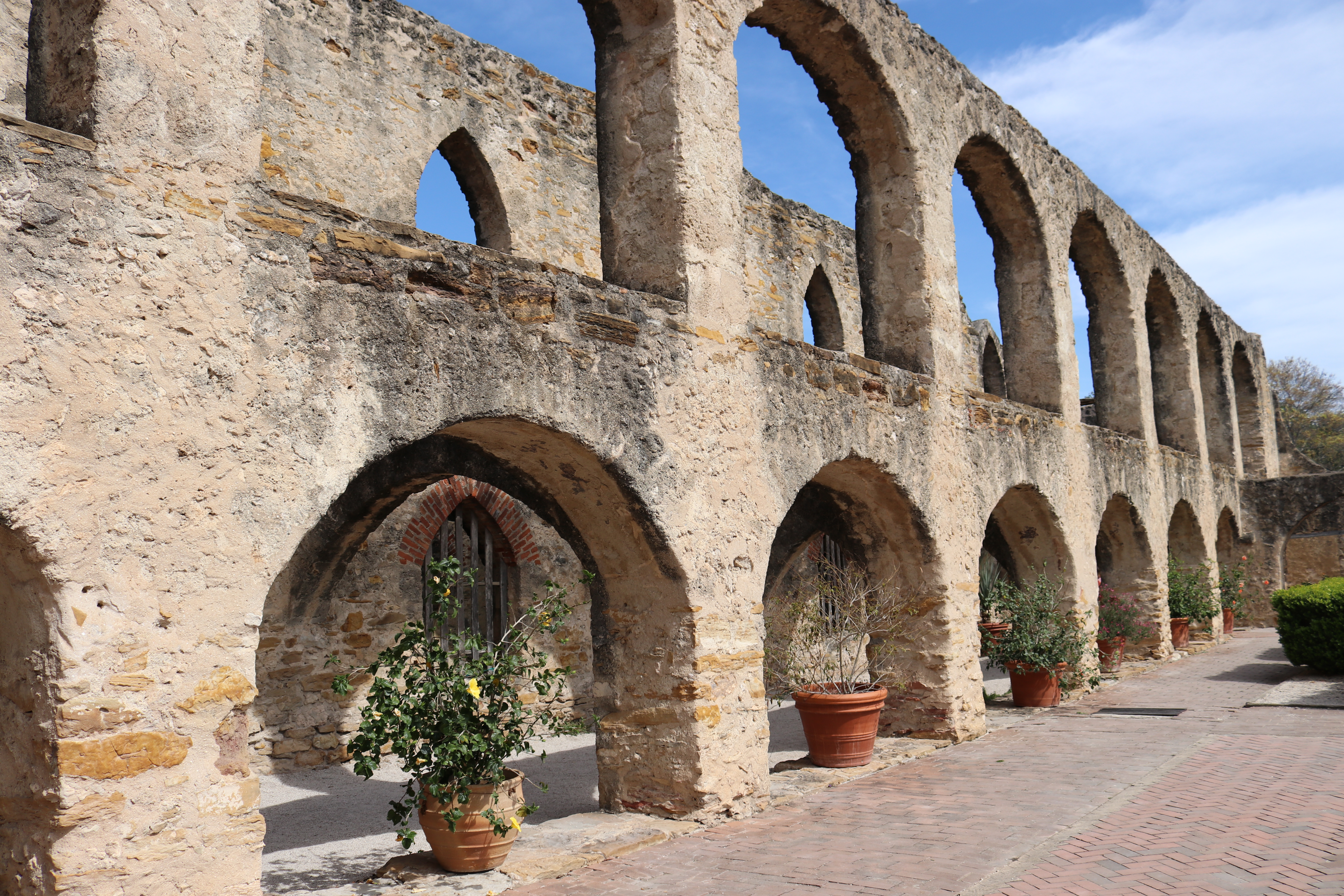 Landscape view of limestone convento arches at Mission San Jose.