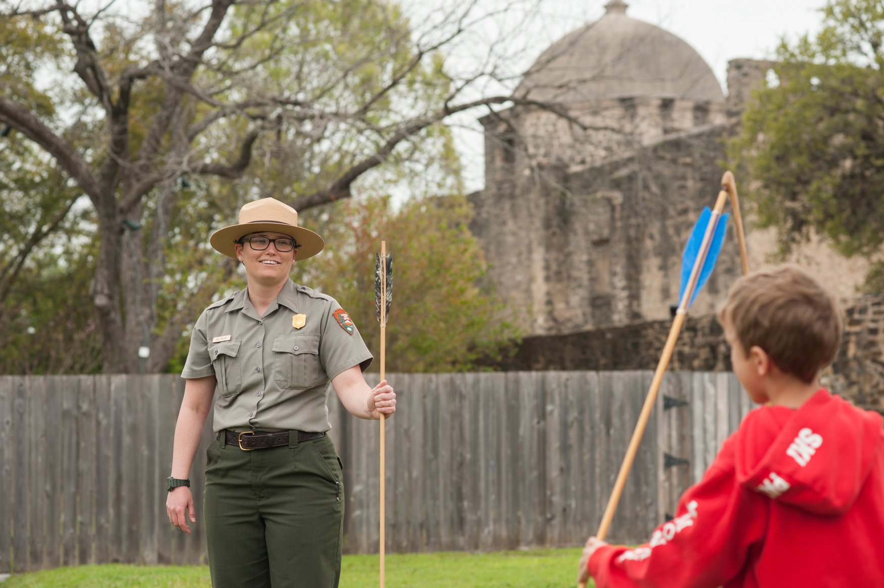 Park Ranger with Atlatl Park Ranger with Atlatl and kids watching.