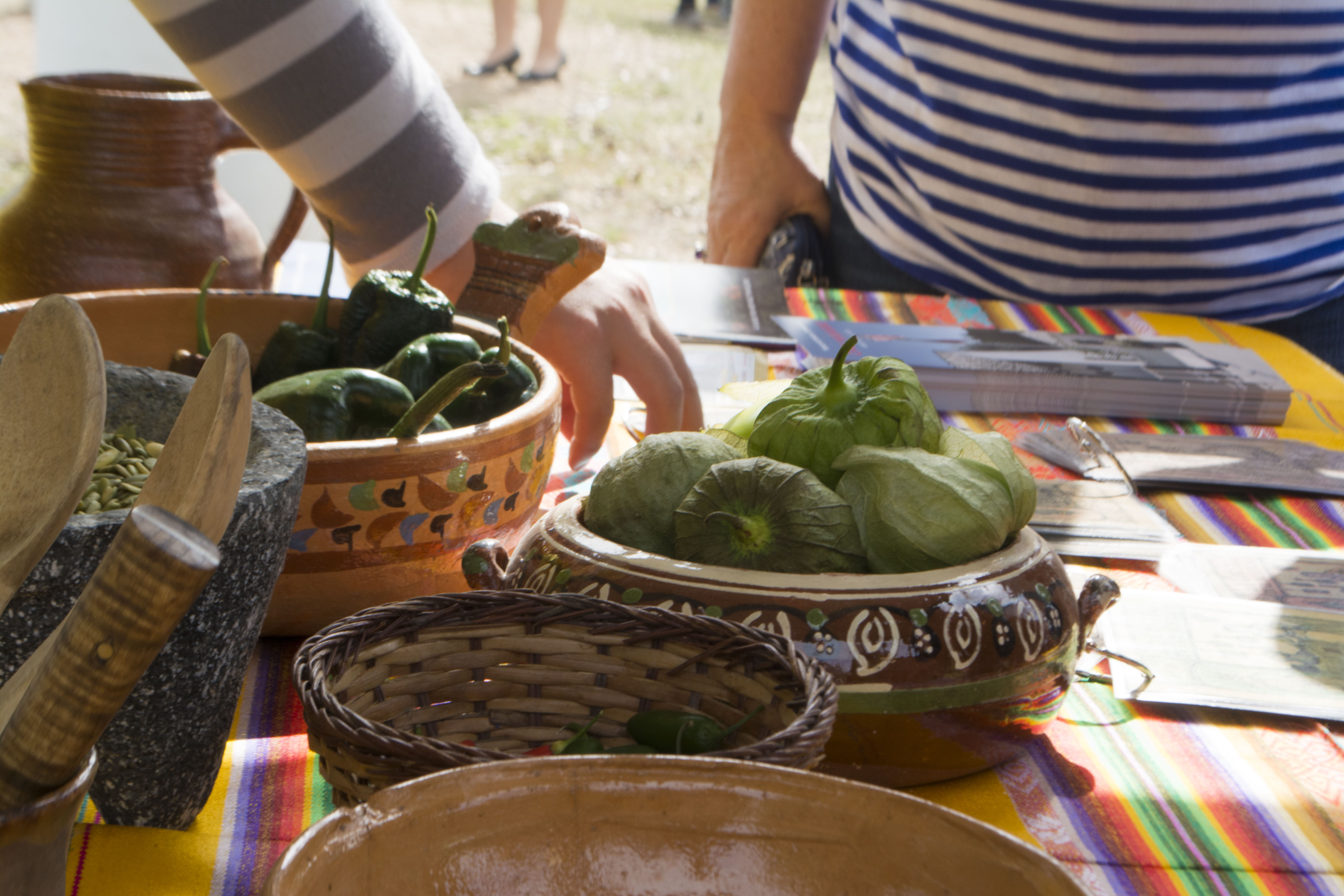 historic cooking 9 Tomatillos and other ingredients on a colorful table.