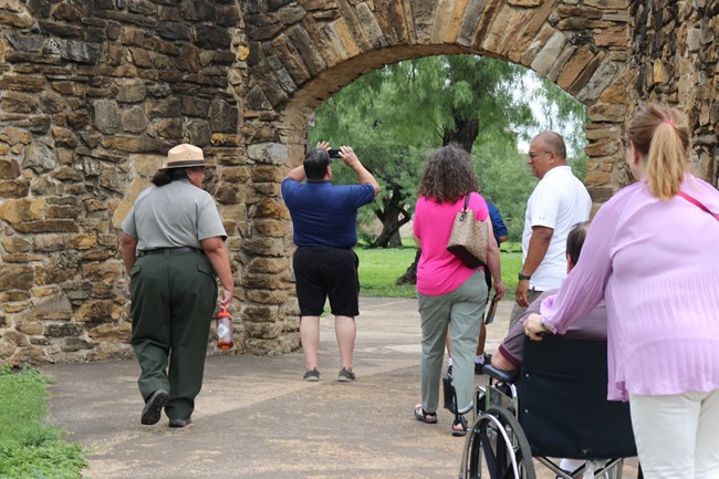 Park Ranger guiding a group into Mission San José.