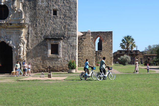 Bicyclists in front of Mission San José church.