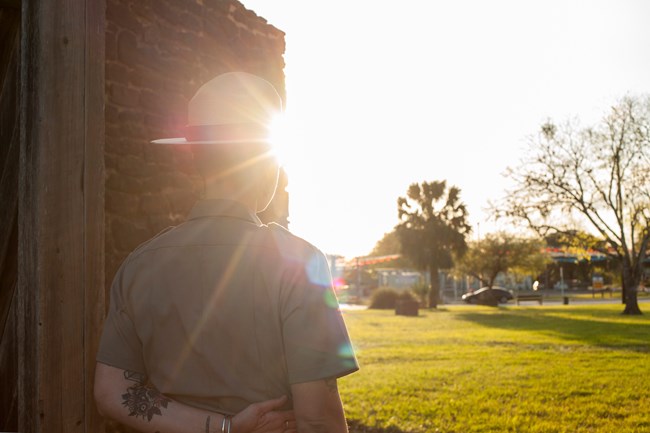 Park Ranger looks out of mission toward the city