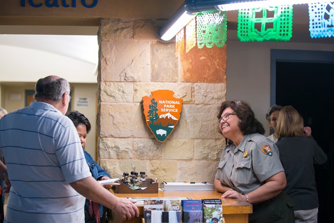 Park Ranger assists visitor at the front desk of Visitor Center.
