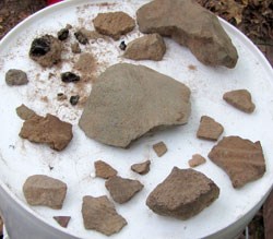 Fire cracked rocks, charcoal and pottery fragments evcavated by archeologists