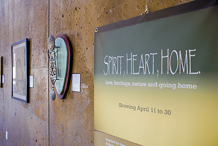 Art exhibit hangs on wall.