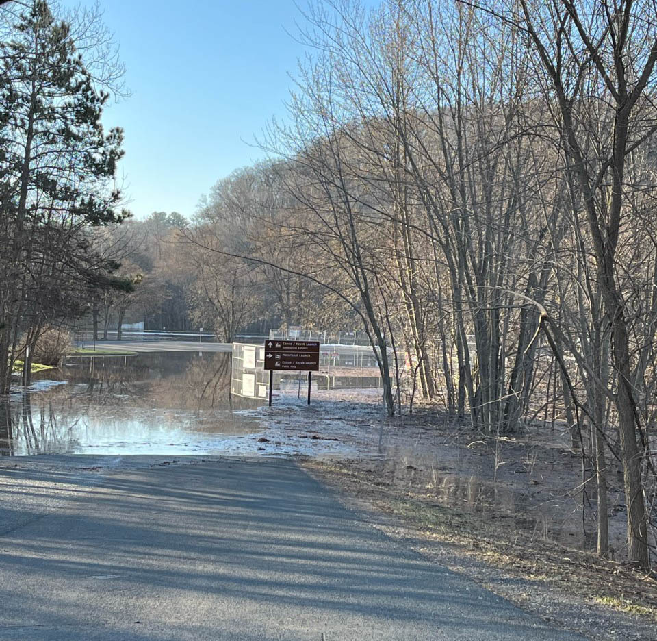 Parking lot and landing flooded with river water coming over the banks