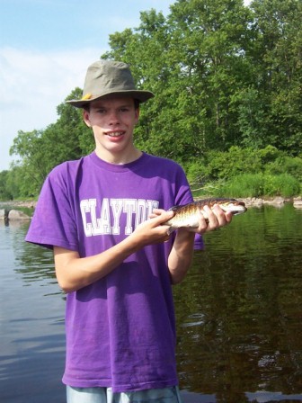 A young angler shares a tradition: a bronze river smallie caught in the river. Dale Cox photo